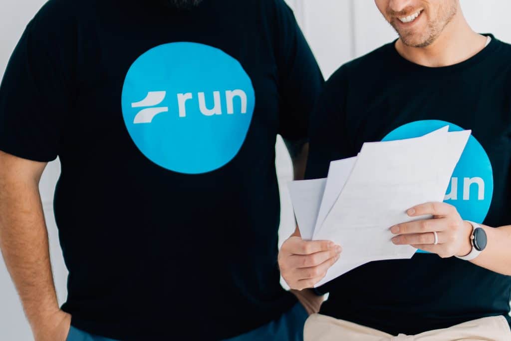 Run Digital team member reviewing a printed SEO report